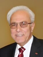 Porträt eines älteren Mannes in Anzug und Brille, Vertreter der TSG Sonnenberg, bei einer offiziellen Veranstaltung.